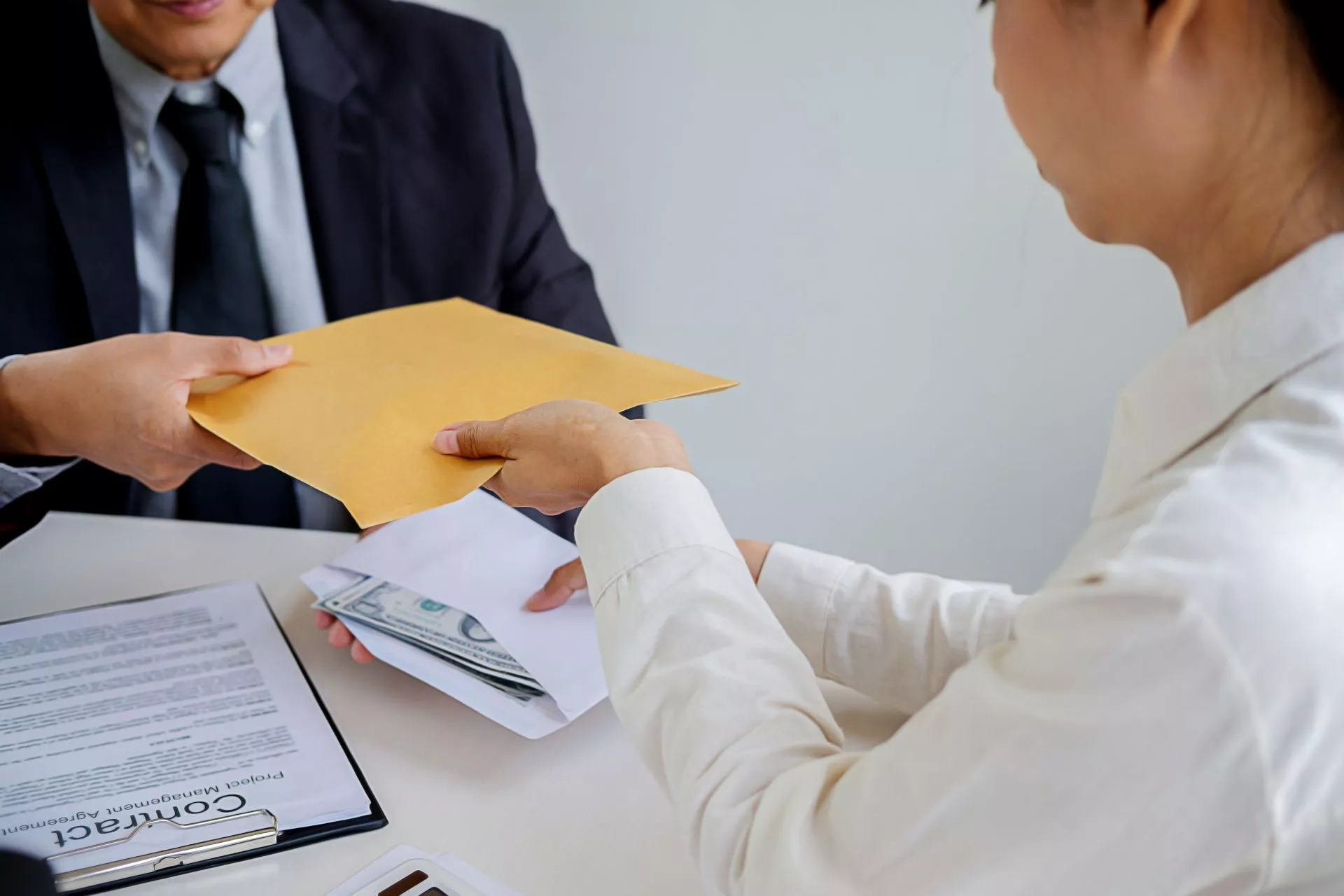 台中當鋪借款示意圖：客戶與當鋪人員辦理典當流程，遞交信封與現金，桌上擺放合約文件，呈現台中當鋪借款流程、利息計算與合法典當交易情境。